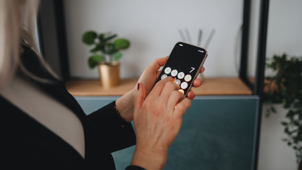 A person using a smartphone inside a home